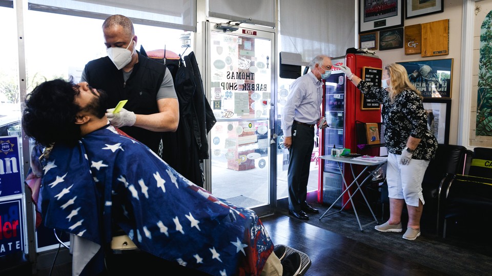 A recently reopened barbershop in Atlanta, Georgia, where people are wearing masks
