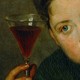 An image of a person examining a glass of wine