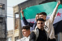 People celebrate in Jableh after rebels ousted Bashar al-Assad Syria on December 9.