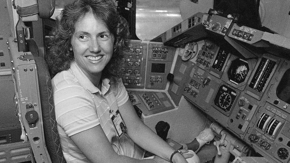 Christa McAuliffe tries out the commander's seat in a shuttle simulator at the Johnson Space Center in Texas on September 13, 1985.