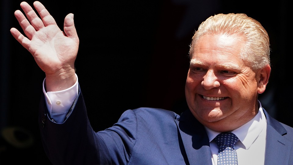 Ontario Premier Doug Ford waves during his unofficial swearing-in ceremony in Toronto in 2018.