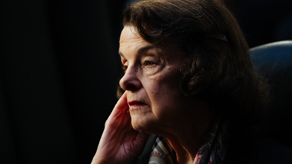 A picture of Dianne Feinstein with her hand to her cheek