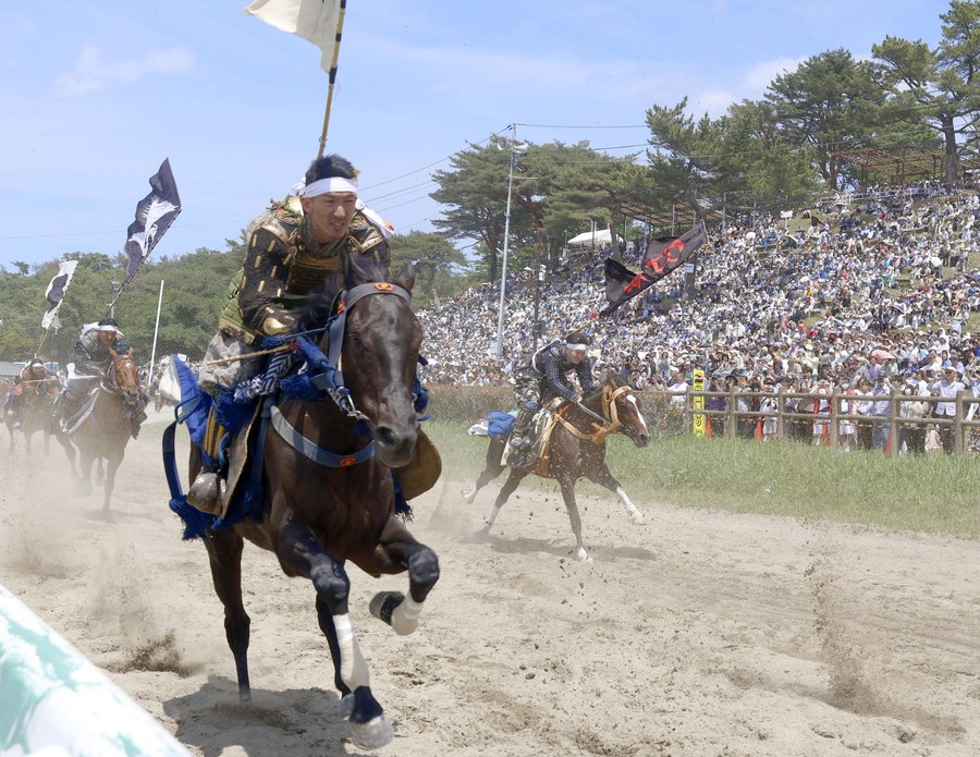 A horse race in Japan, where the riders are dressed as historical armored warriors.