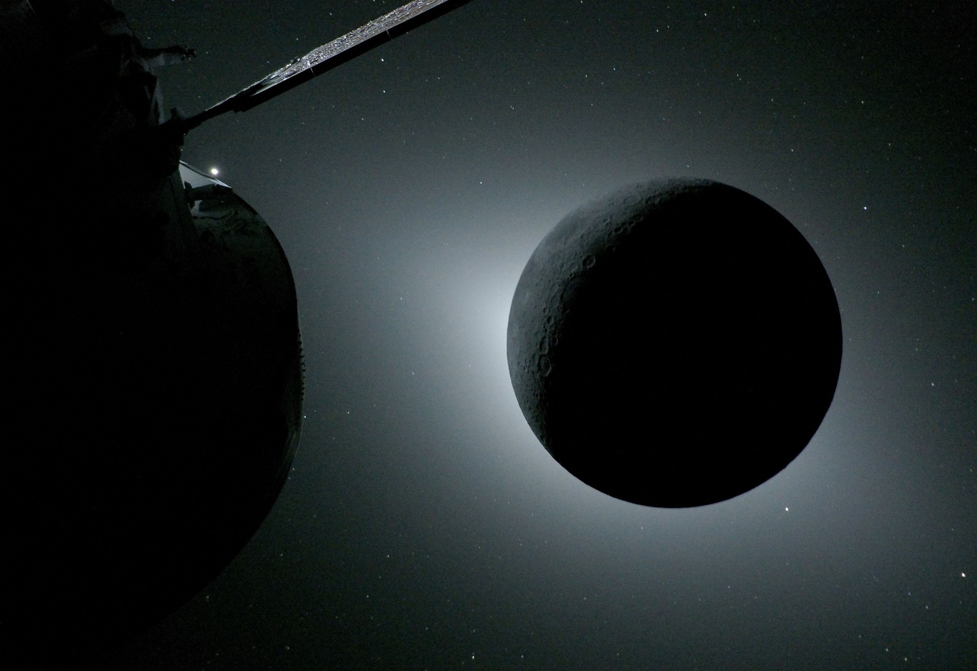 The moon, backlit by the sun during a solar eclipse, as seen from a spacecraft far from Earth.