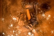 A worker in a protective suit oversees molten iron flowing from a blast furnace at the ThyssenKrupp steel mill in Duisburg, Germany.