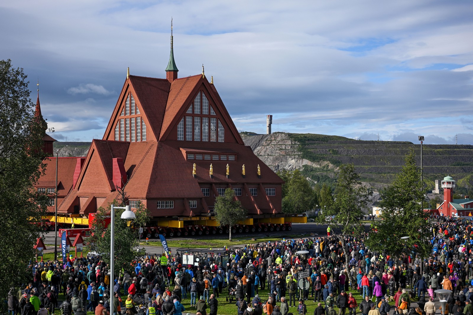 A large crowd gathers to watch a church being moved.