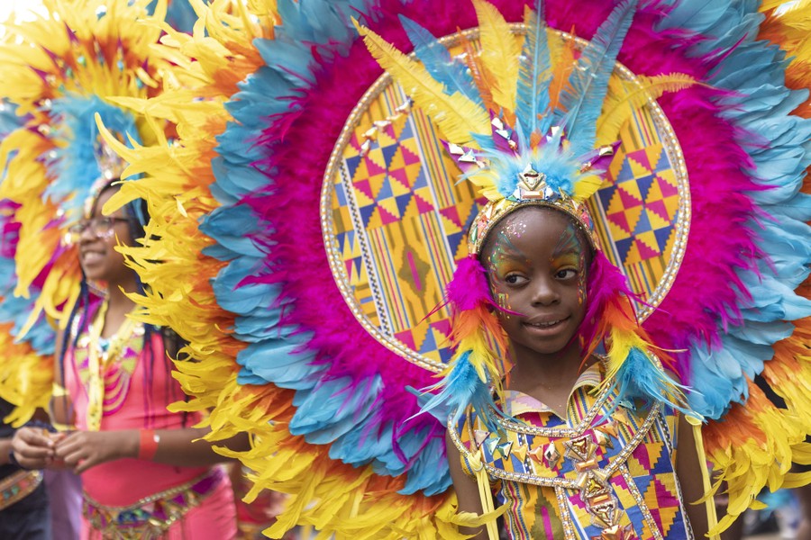 Young performers wear large and colorful costumes.