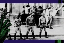 a photo of soldiers and people lined up against a wall