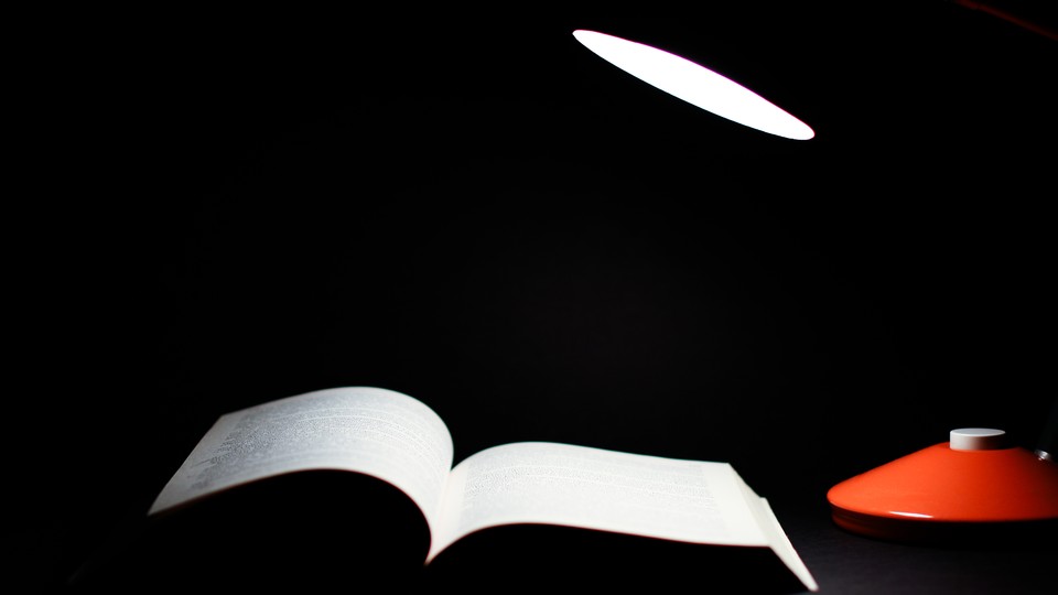 A lamp shining a light on a book