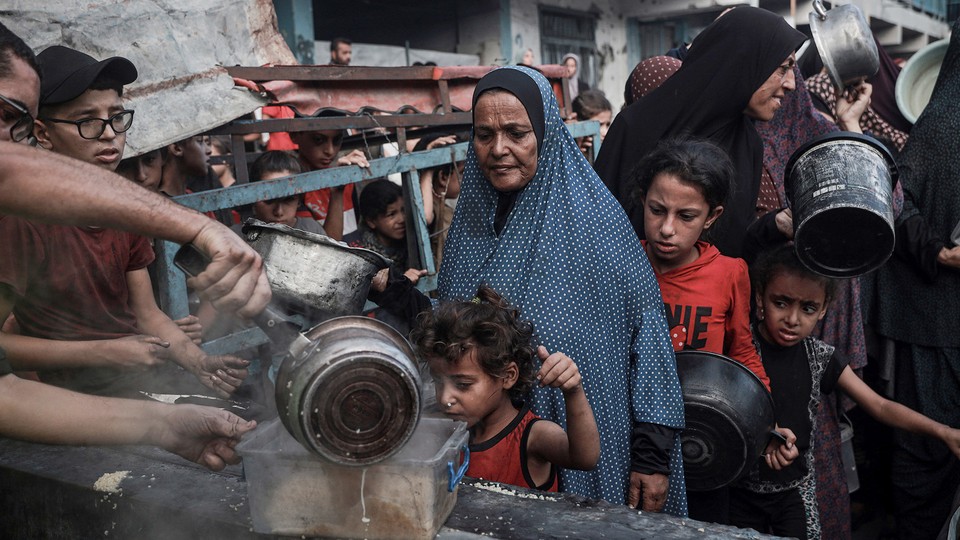 A line for hot meals in Gaza's al-Zeitoun neighborhood