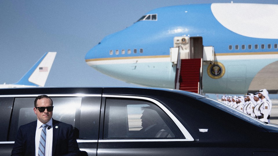 Photo of Donald Trump in a black car with Air Force One in the background