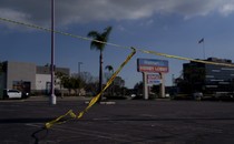 Picture of a parking lot, crossed by crime-scene yellow tape