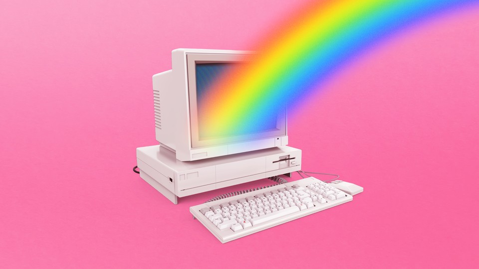 An old desktop computer with a rainbow projecting from the screen on a field of pink
