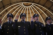 Chicago Police officers line up to be presented their certificates during the graduation ceremony for the Department's newest recruits in Chicago, Illinois, April 21, 2014.