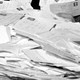 A black and white photograph of a pile of postmarked envelopes