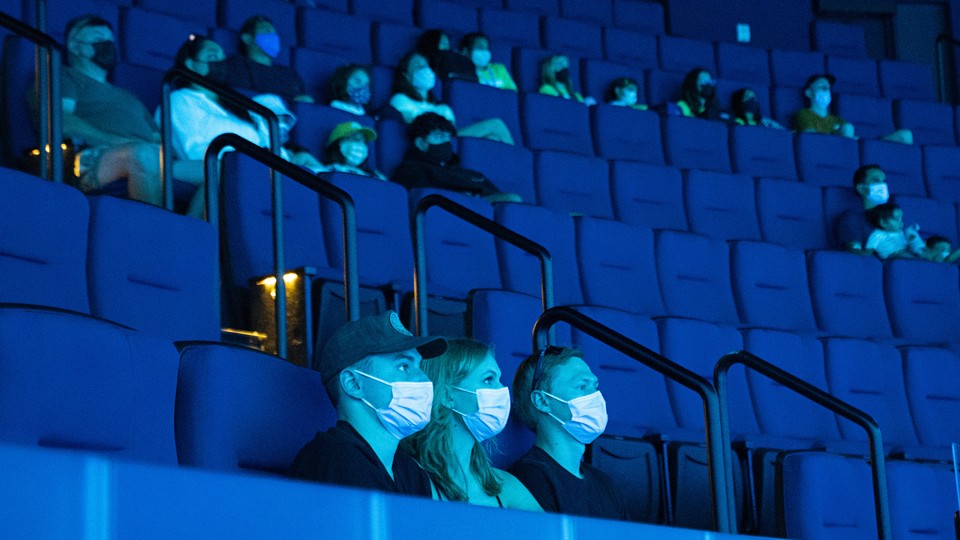 masked people in a movie theater