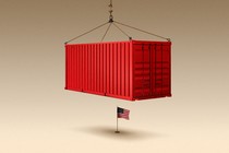 A shipping container, held up by a crane, hanging over the American flag