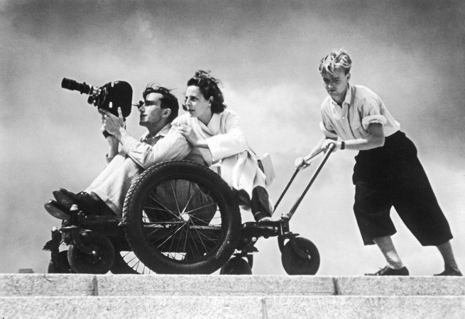 A black and white photo of Leni Riefenstahl during filming