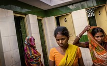 Women waiting to use a community toilet in India