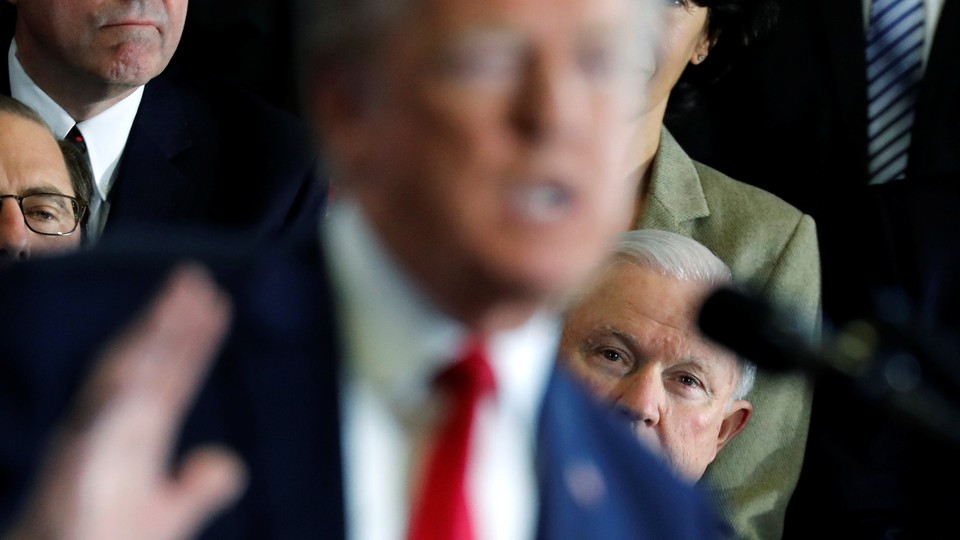 At a March 19 event in New Hampshire, Attorney General Jeff Sessions watches President Trump give a speech about the opioid epidemic.