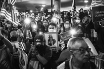 Demonstrators hold placards and American flags during a rally in support of the Hong Kong Human Rights and Democracy Act, in Hong Kong, China, on Monday, Oct. 14, 2019.