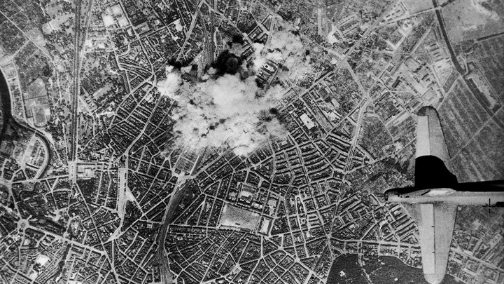 Bombs from U.S. Flying Fortresses explode on the Vahrenwalder-Strasse, in Hannover, Germany, where rubber tires for the German war machine are produced