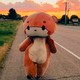 A man in a bear suit walking along a road