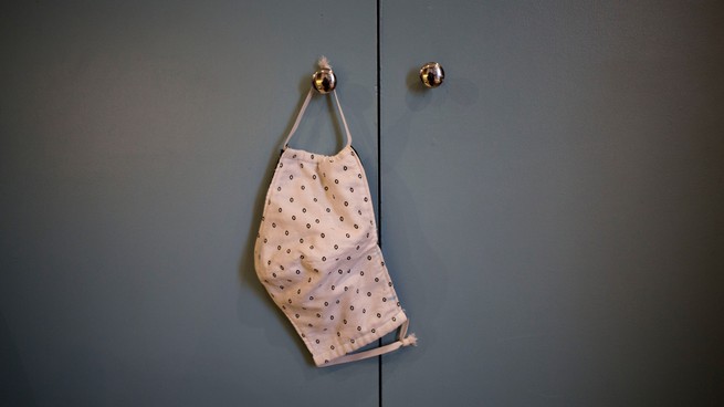 Mask hanging on a door knob