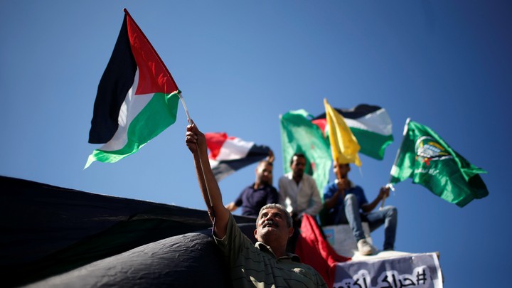 Palestinians celebrate after Hamas said it reached a deal with Palestinian rival Fatah, in Gaza City.