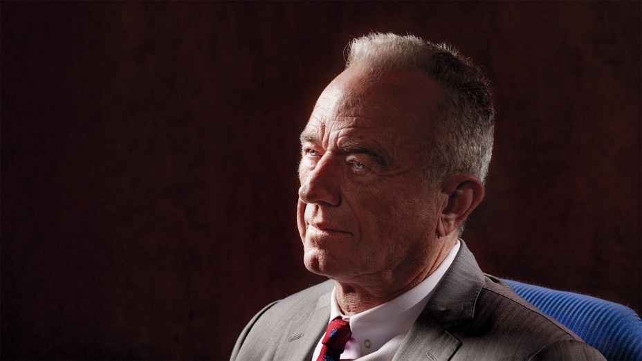 head-and-shoulders photo portrait of RFK Jr. in 3/4 profile wearing suit and tie