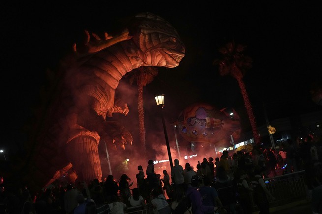 Revelers take in a nighttime parade in Santiago, Chile