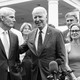 Biden surrounded by senators, while addressing the media