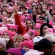 a crowd of women wearing pink hats