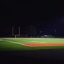 An empty football field at night.