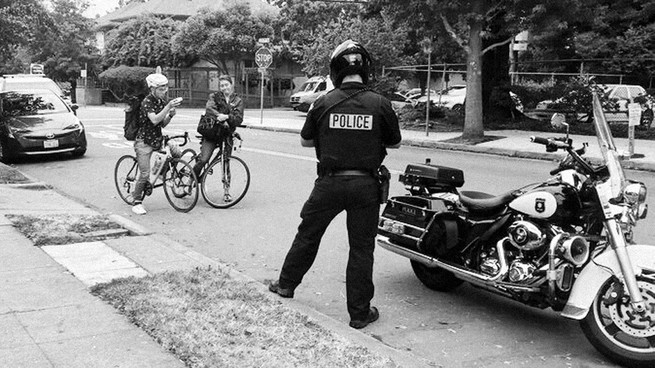 An officer writing a ticket.