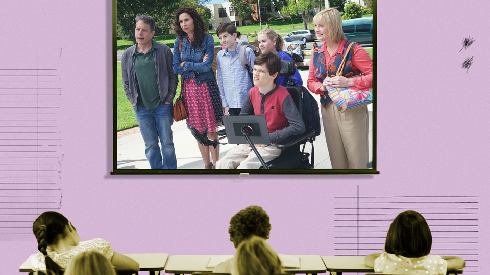 A frame from the ABC show "Speechless" is superimposed on a projector screen in a classroom.