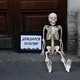 During Russian protests against the raised retirement age, a fake skeleton is seated next to a sign that says, "Waited for the pension."