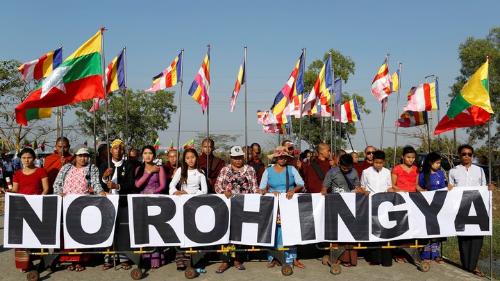Buddhist monks and Yangon residents protest the arrival of an aid ship bringing humanitarian supplies to Rohingya Muslims in Yangon by holding a sign that reads "No Rohingya" in February 2017.
