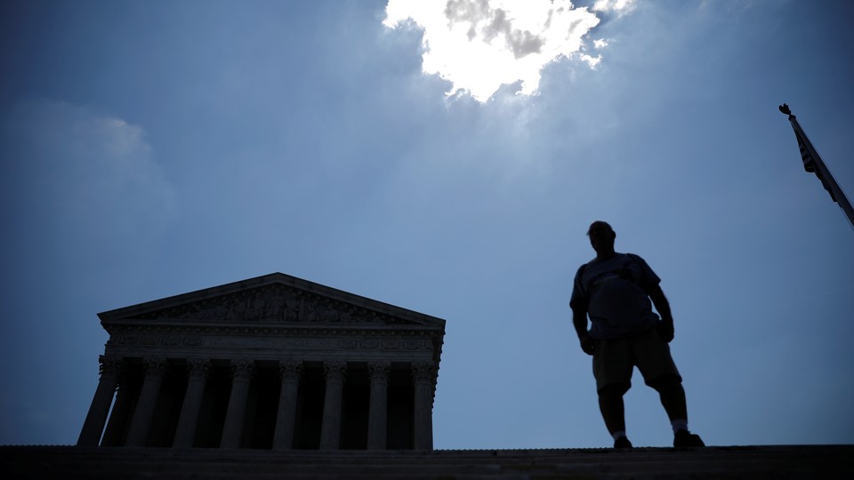 A man stands outside the U.S. Supreme Court after the Court ruling on June 27.