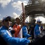A French athlete, surrounded by Chinese security officers, carries the Olympic torch in Paris in April 2008.
