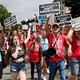 People hold up signs that read "I am the post-Roe generation" and "The future is anti-abortion."
