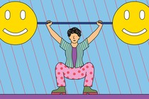 A person lifts a large barbell with smiley faces on either end.