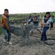 Children carry a part of a missile