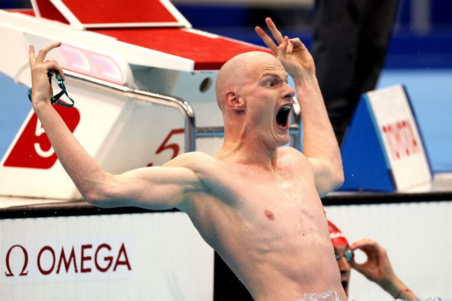 A swimmer reacts emotionally after winning a race.