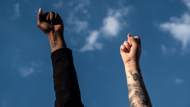 Two fists raised to the sky