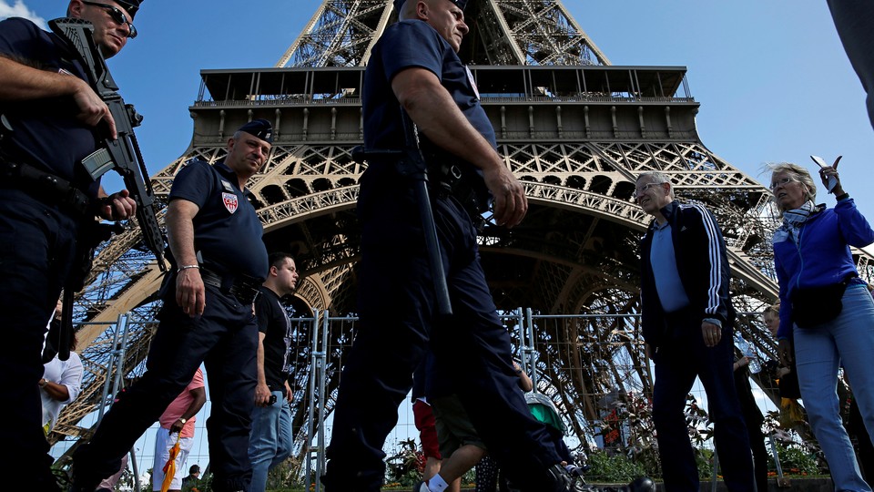 French policemen on patrol by the Eiffel Tower in Paris.