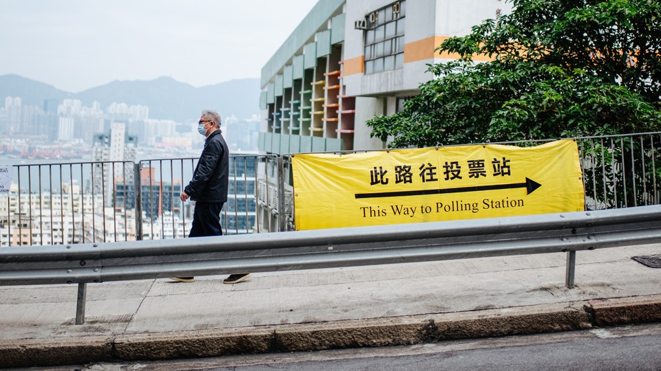 A man walking by a Hong Kong polling station