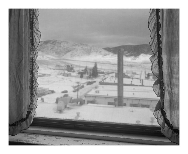Een raamuitzicht op een besneeuwd landschap