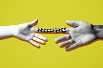 Two hands stuck in a finger trap, pulling away from each other