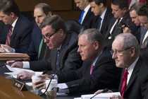 Five men from the Senate Intelligence Committee sit at a desk